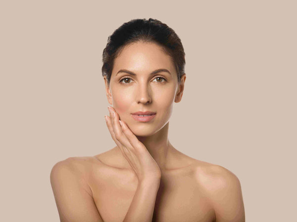 beautiful woman with dark hair touching the side of her face