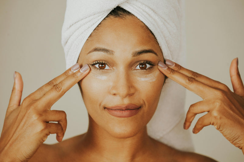 A young woman applies daily SPF